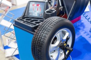 Why a spinning wheel shakes a car at highway speed and how a wheel balancer finds the heavy spot